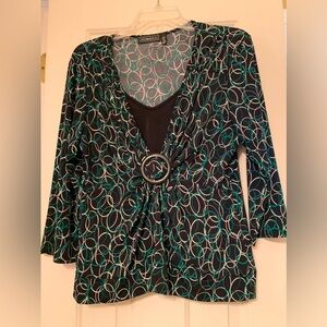 A green, black and white swirled polyester top